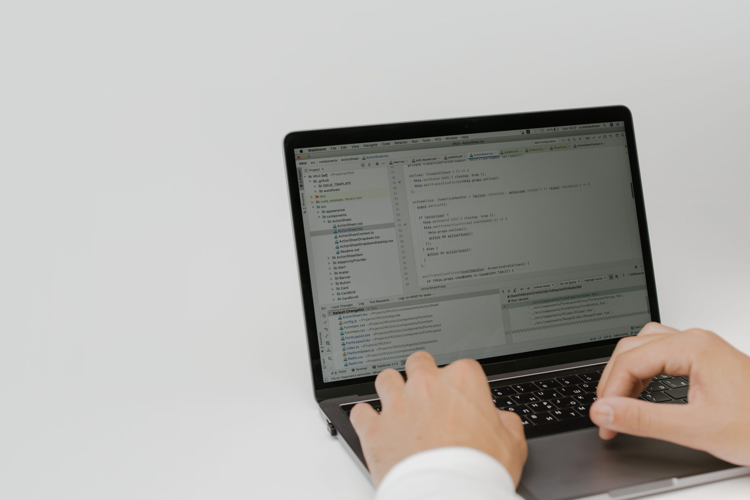 Developer editing TypeScript code on a laptop, refining a generated Amplify Gen 2 backend