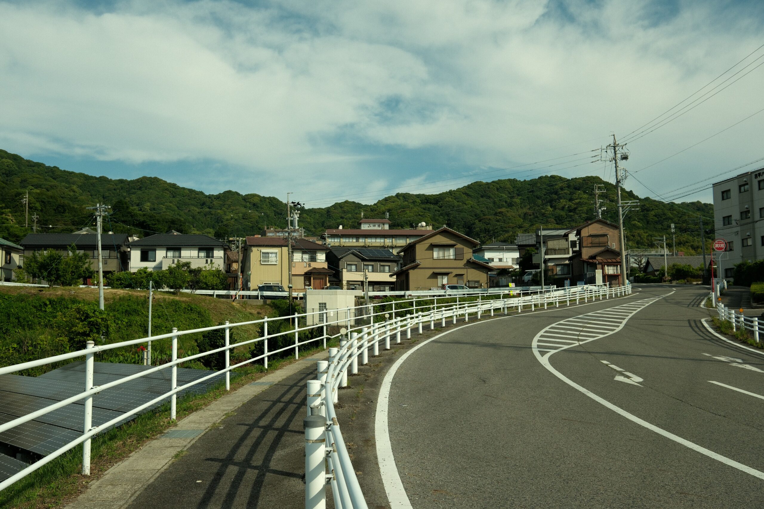 Quiet suburban residential street in Japan where households set out sorted trash