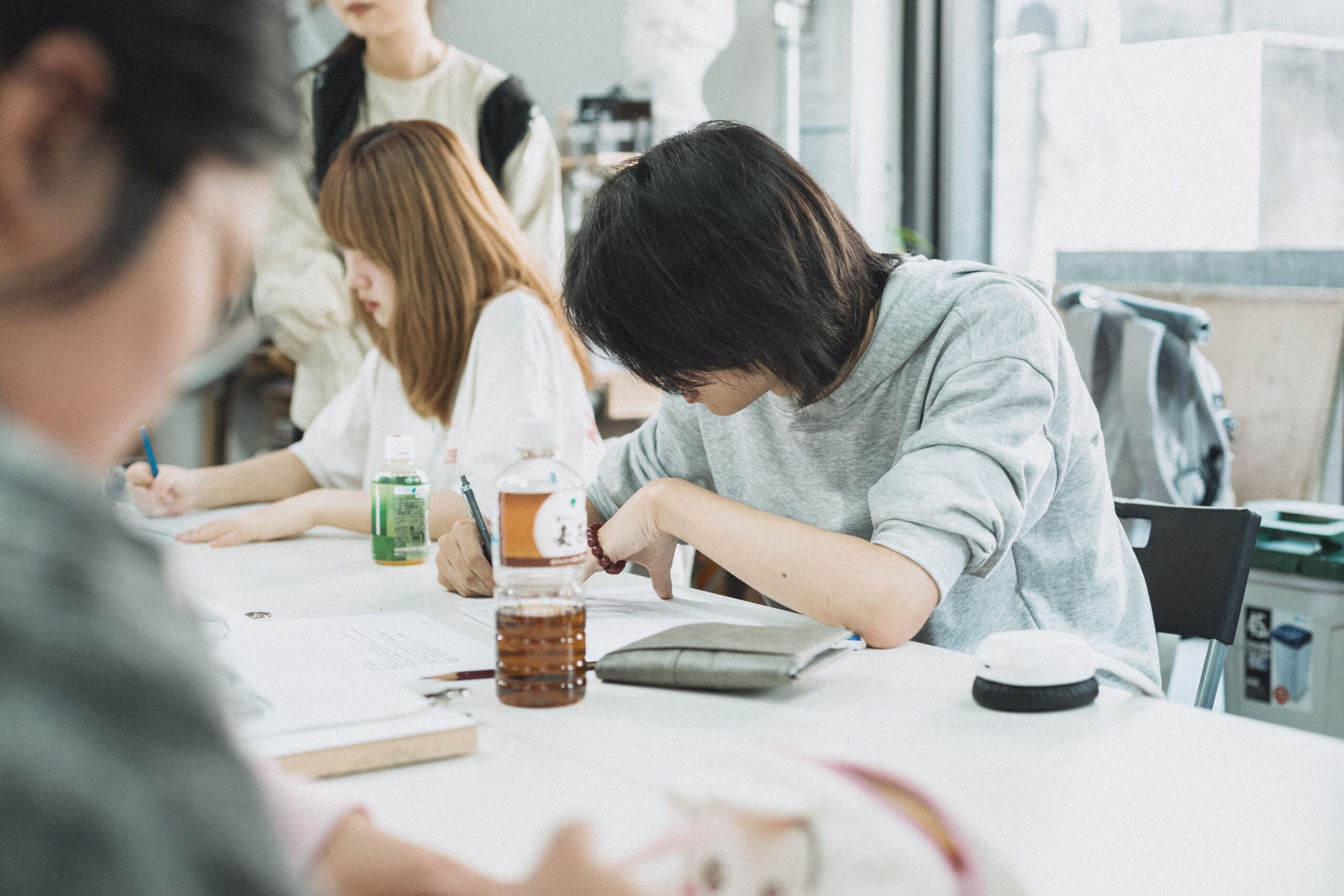 Students studying together at a table in a bright classroom in Japan