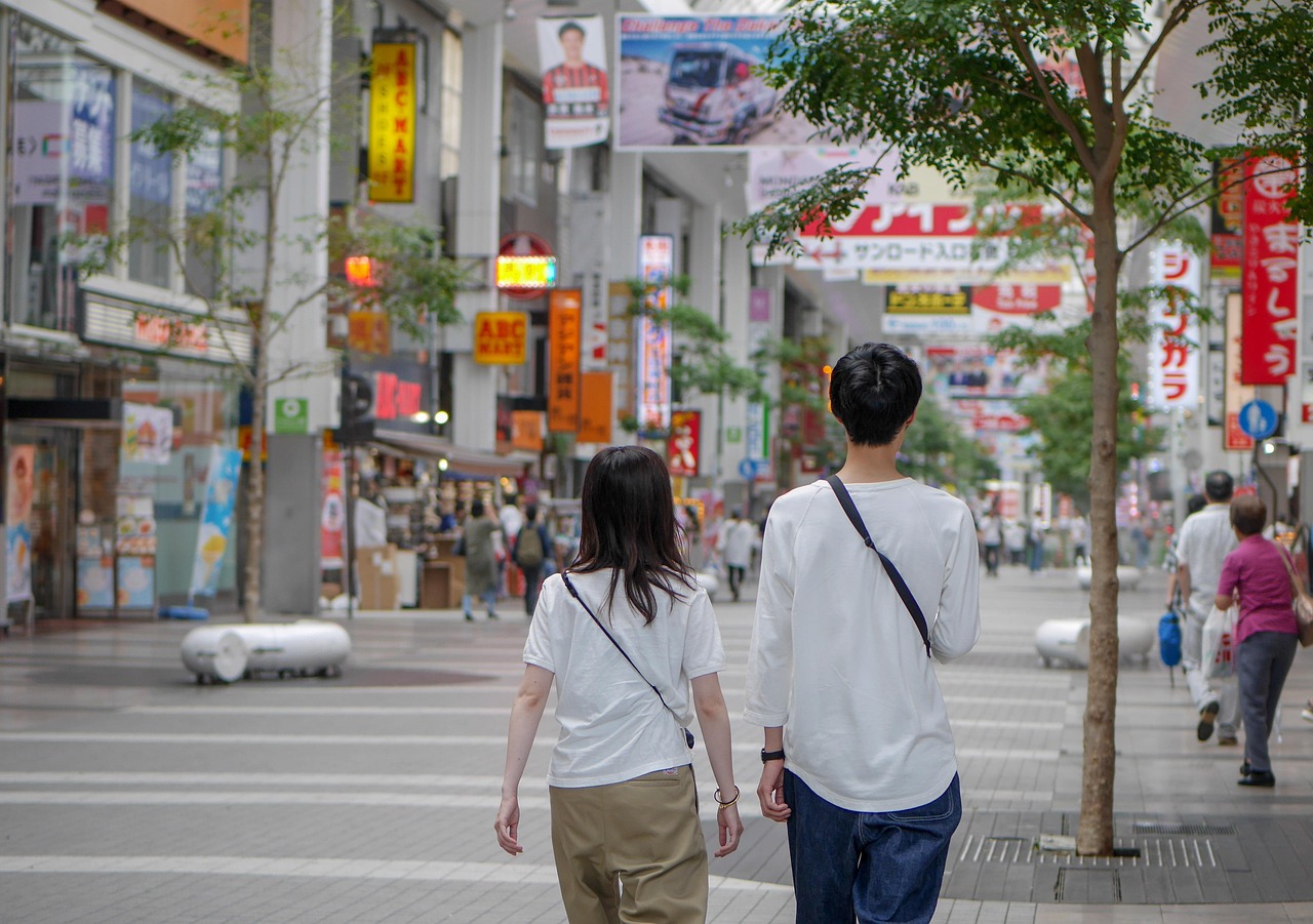 Shoppers walking through a covered shopping arcade lined with stores in Japan