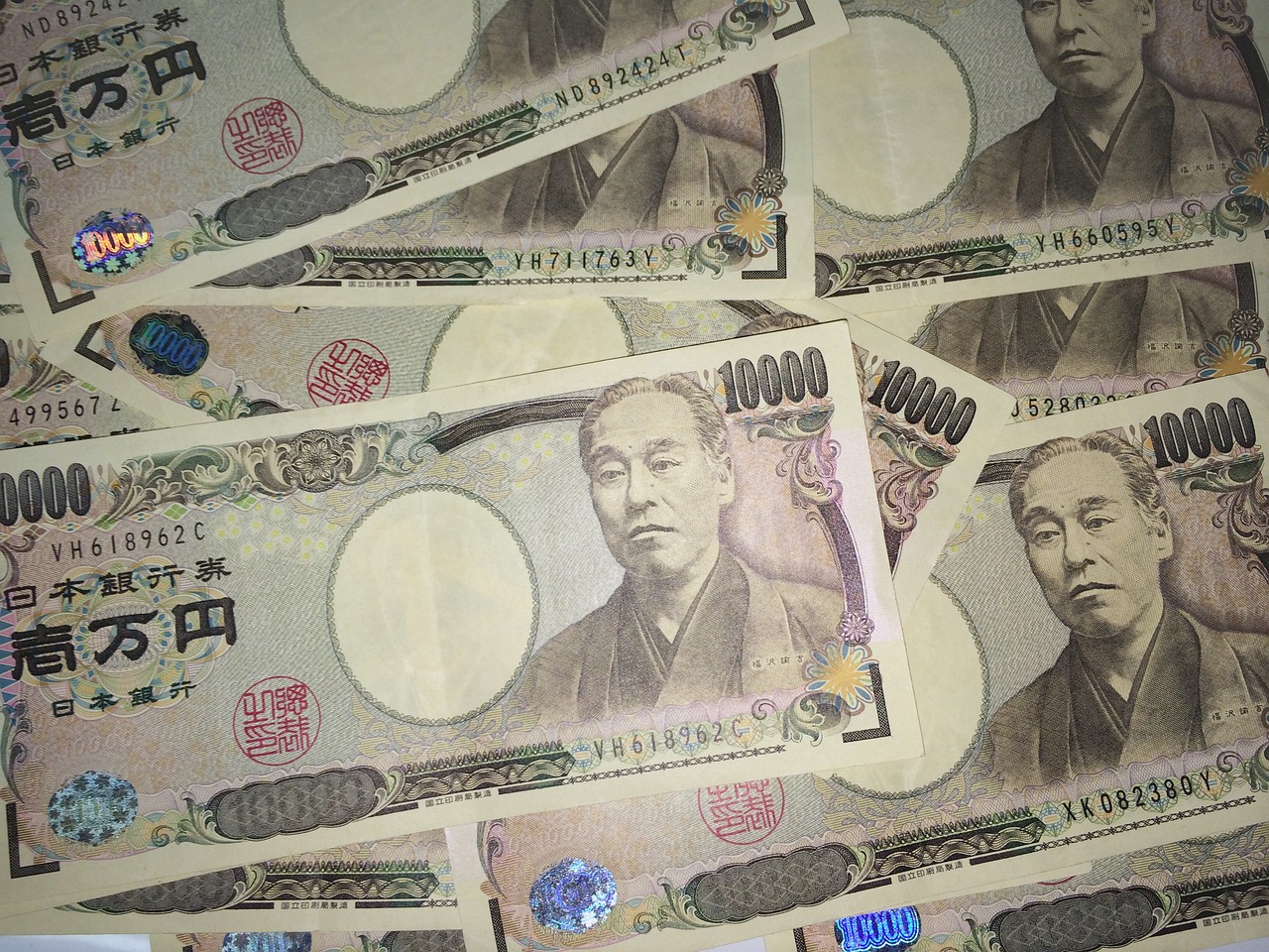 A pile of Japanese ten-thousand-yen banknotes, representing fees and regulated payments