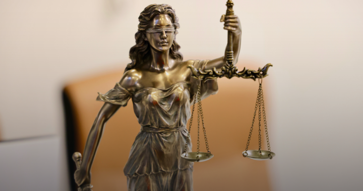 A bronze statue of Lady Justice holding scales and a sword