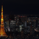 Tokyo Tower illuminated at night above the dense city skyline