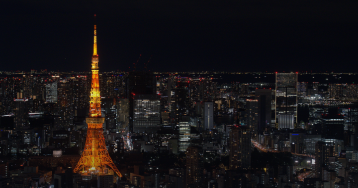 Tokyo Tower illuminated at night above the dense city skyline